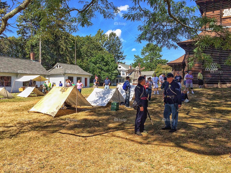 Guard and people standing outside the tent