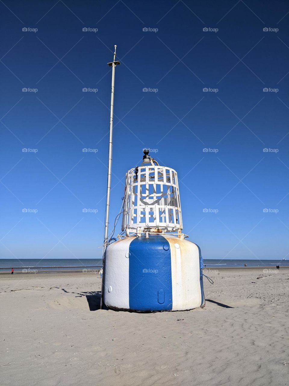stranded buoy in Blue and white