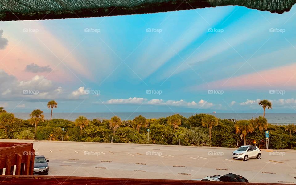 Central Eastern Florida Atlantic Ocean Beach View From Restaurant Outdoor Terrace Patio Enjoying The Incredible Rare Sunset Effect In The Sky.