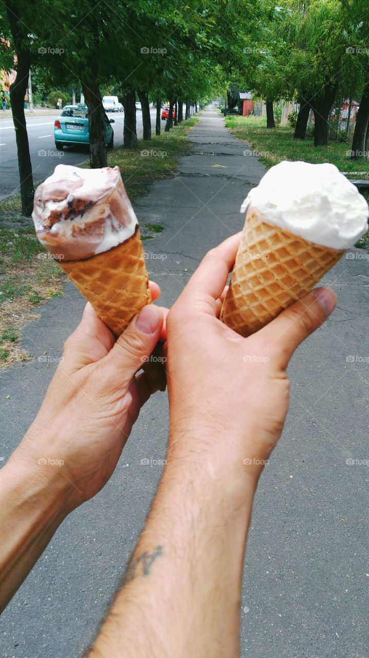 Men's and women's hands hold ice cream