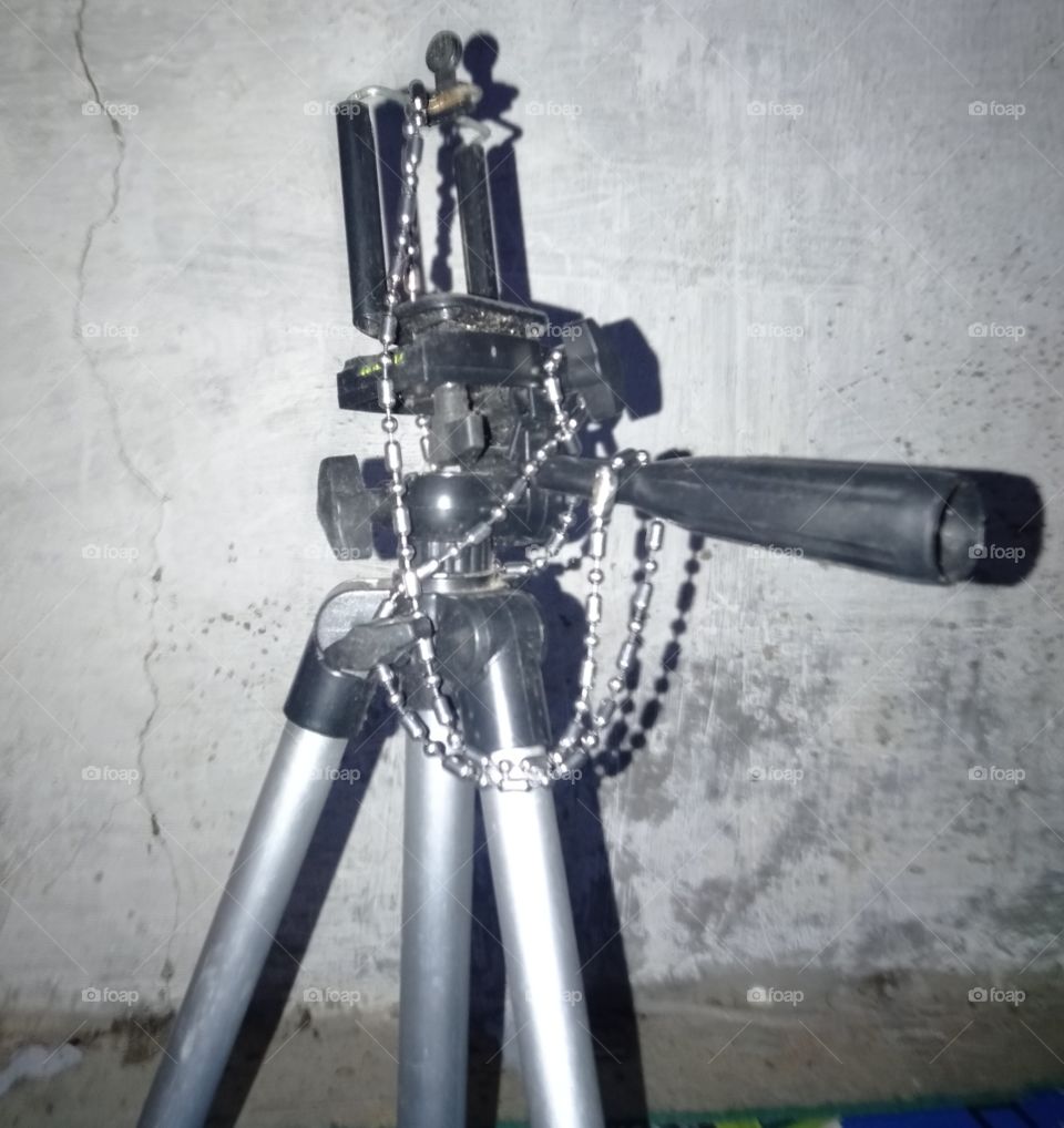A necklace wrapped around a tripod is like a romantic movie story with all the stories that are very memorable