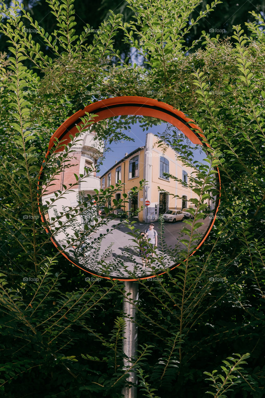 Selfie in a traffic mirror, summer travels, European town.