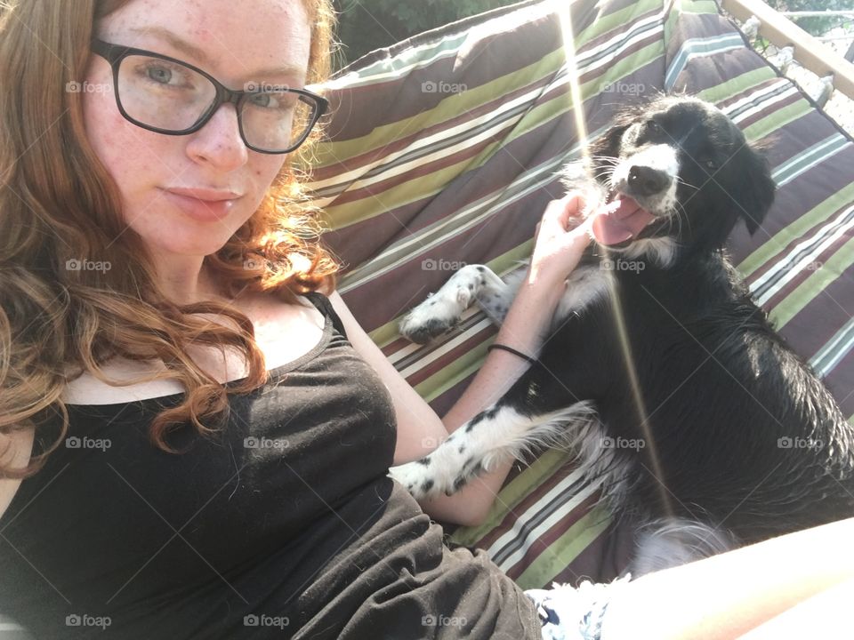 red head blue eyes on hammock with dog