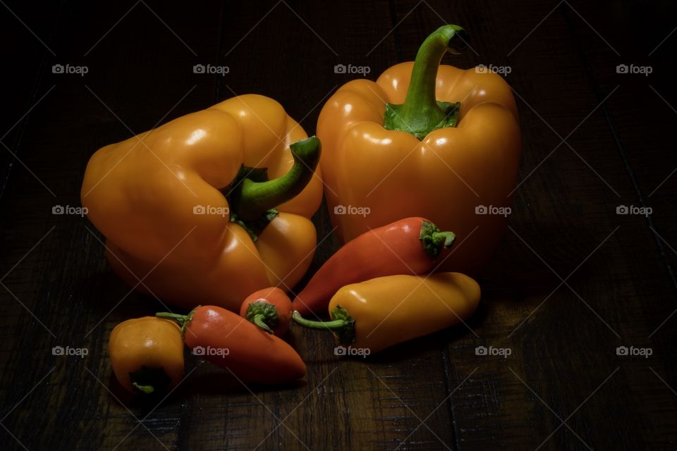 Foap, Light: Natural vs Artificial - Still life of some yellow and red bell and sweet peppers on a dark wood background. Used an LED ring lamp as a light source. 