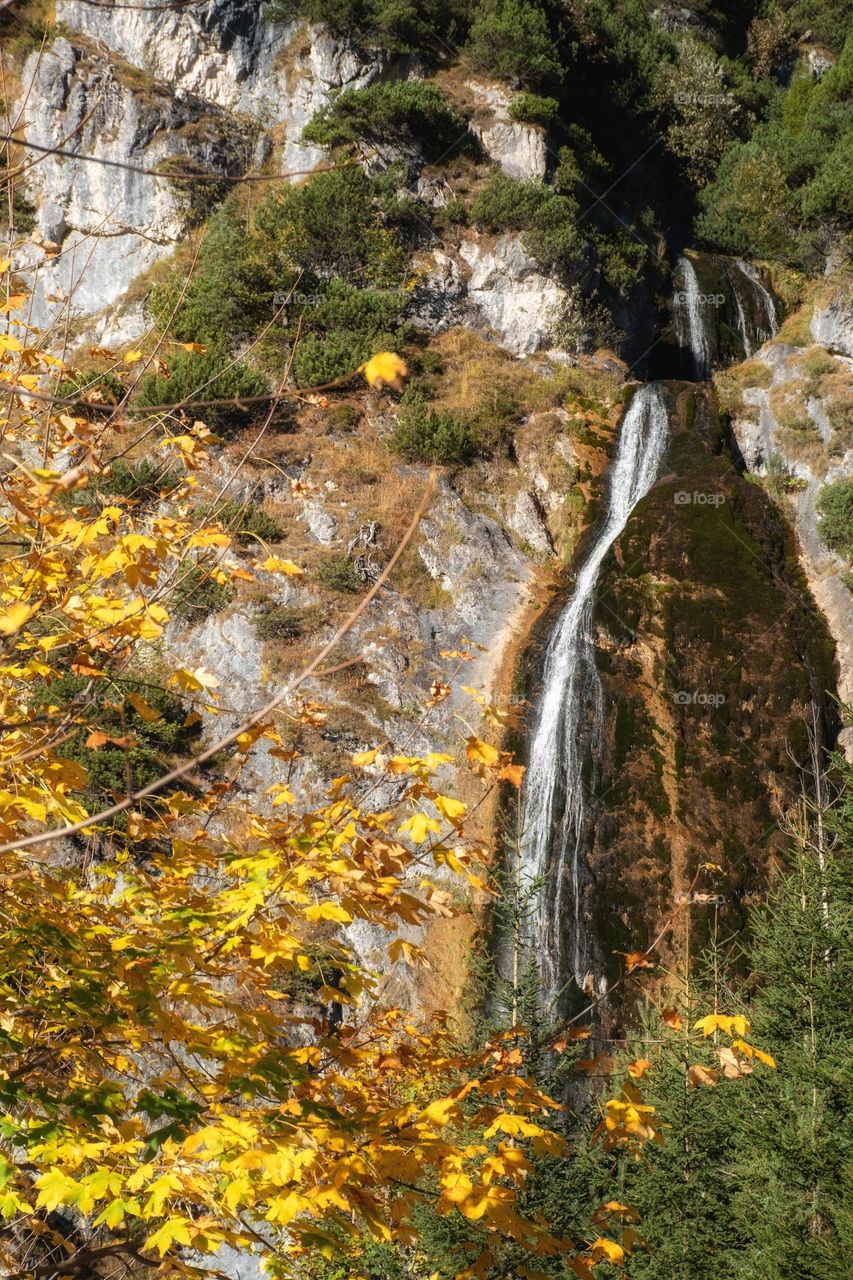 Beautiful Waterfall in Autumn Mountain Forest