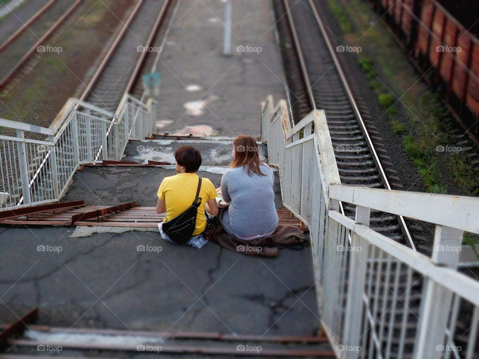 man and woman sitting on the stairs