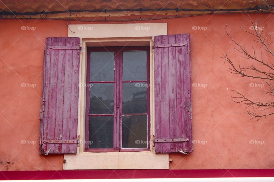 Shades of red . Window in Roussillon, France 
