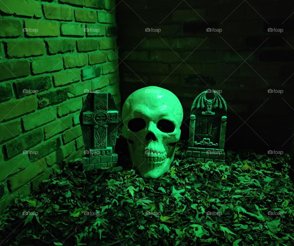Halloween decorations illuminated by green light