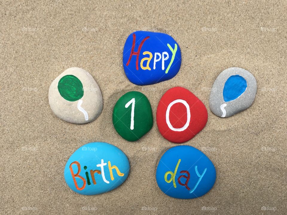 Happy 10 Birthday on colored stones 
