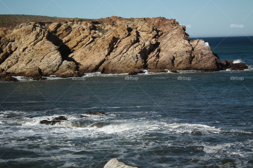 The weary of heart find rest here, in the breeze, and the sight of the rocks standing strong in the sea