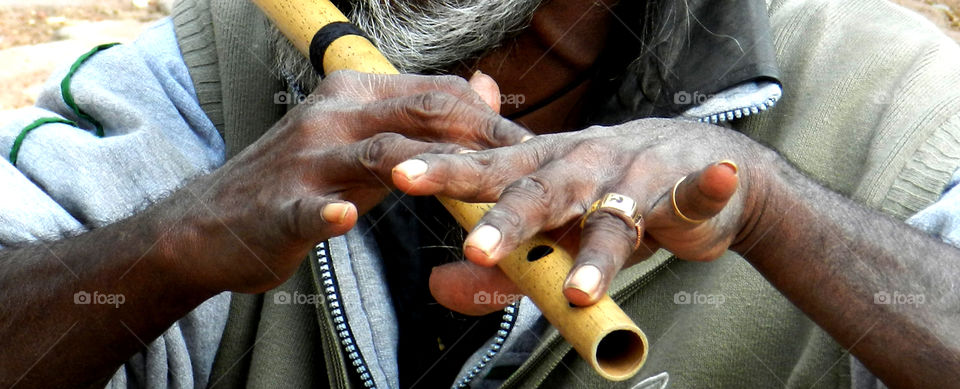 A senior man playing flute