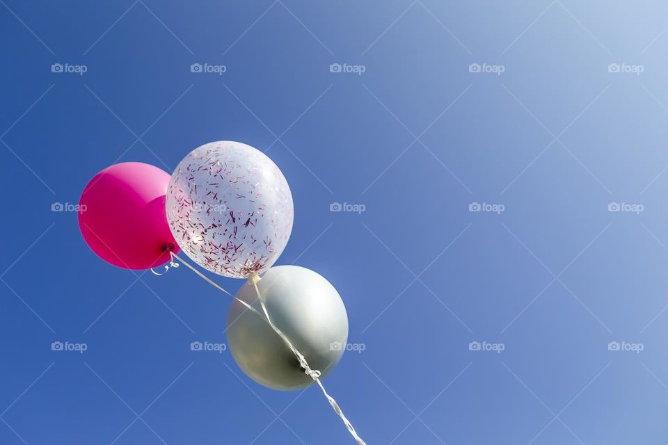 Birthday helium balloons in the sky