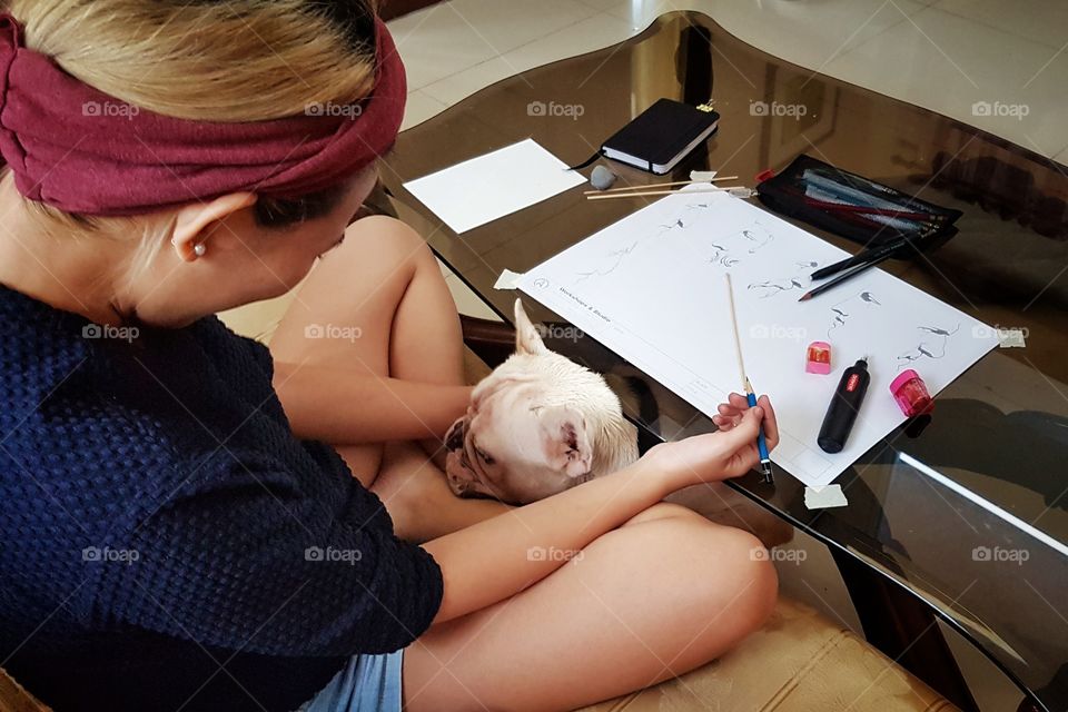girl surprised by dog while sketching