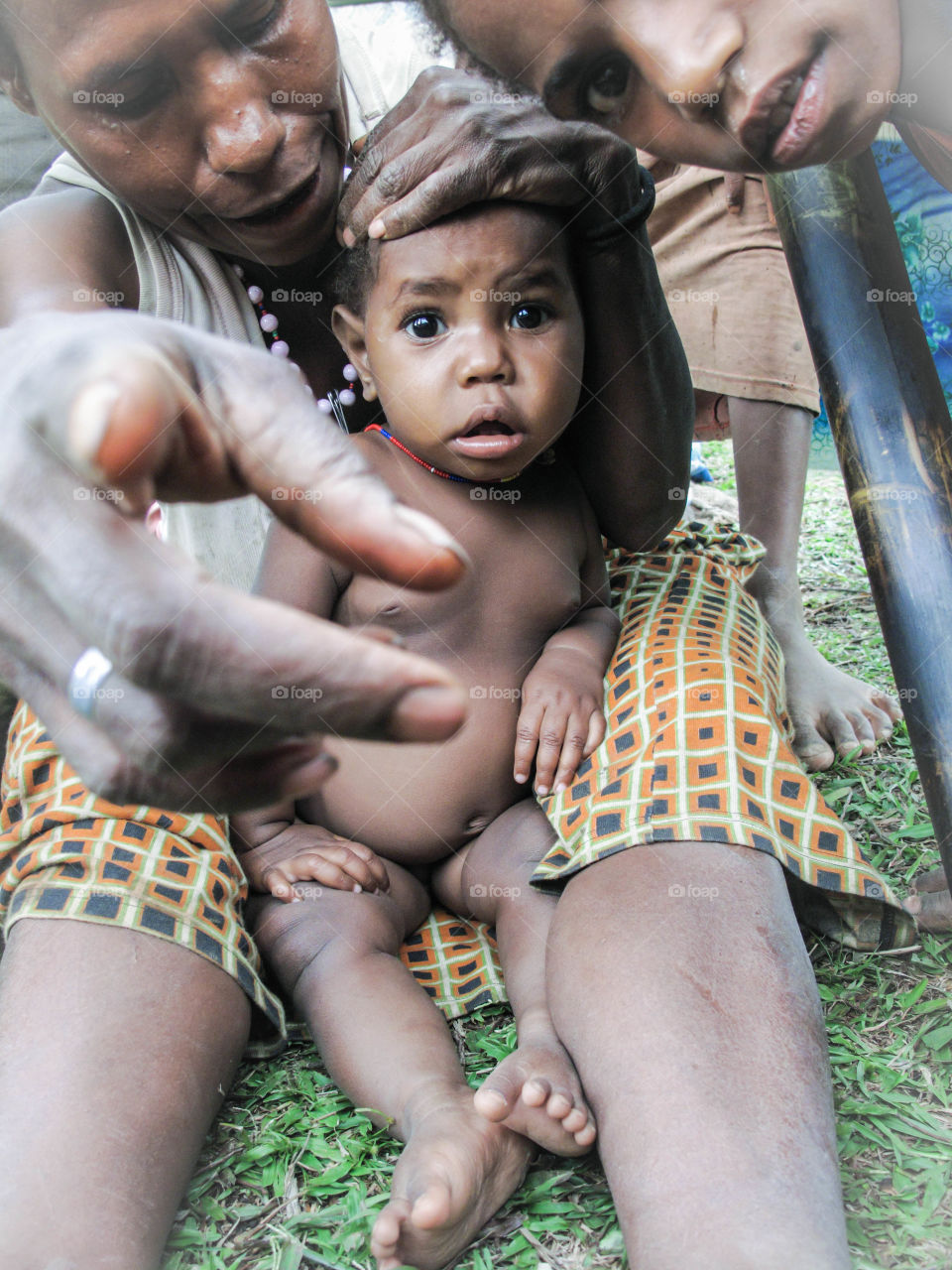 Baby with mother looking surprised, Papua New Guinea