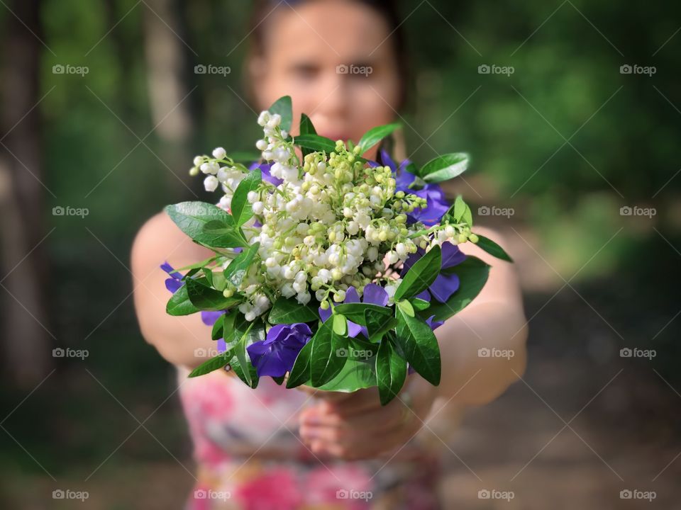 Woman and lily of the valley bouquet 