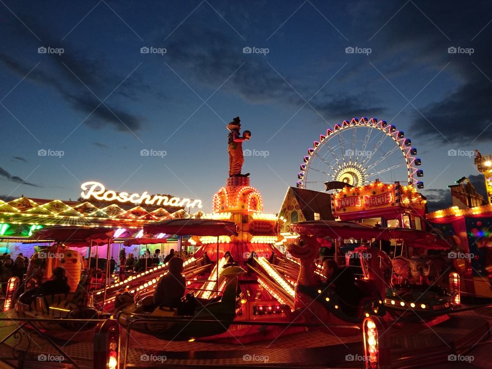Wheel and attractions on the Oktoberfest in Stuttgart