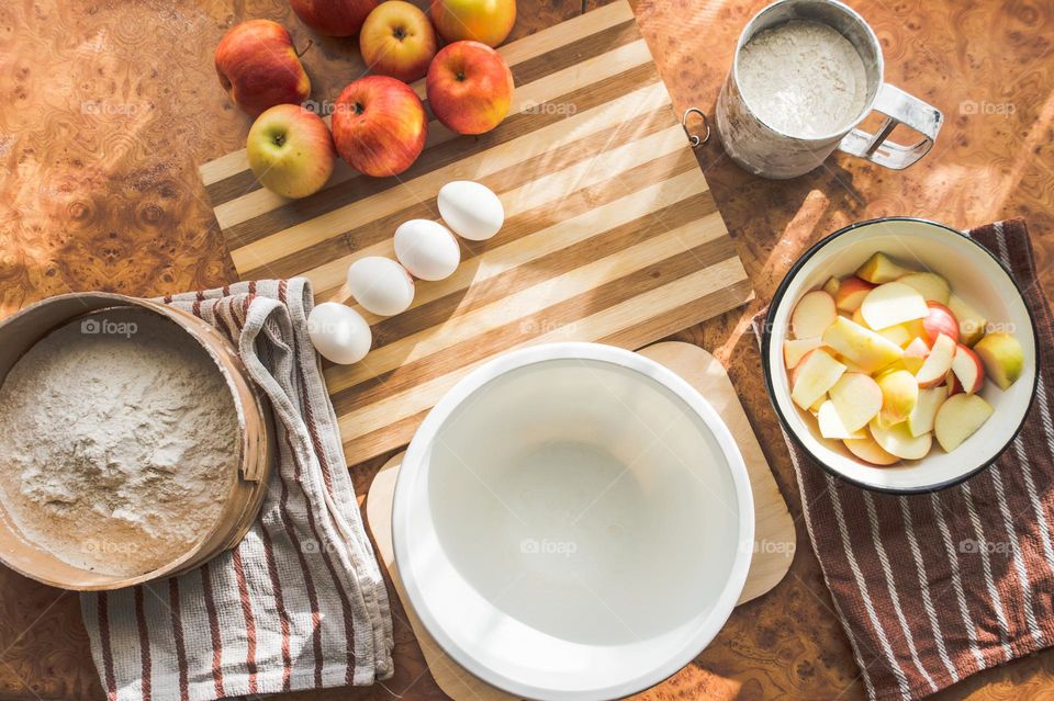 Making homemade puffed apple pie with eggs, sugar and flour.