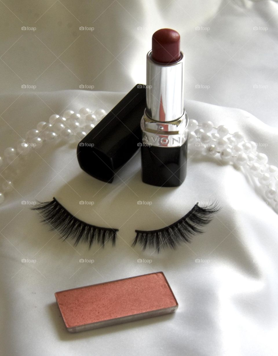 Makeup still life with eye lashes and lipstick 