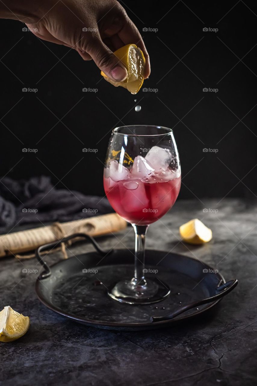 A drop of lemon in cranberry juice.