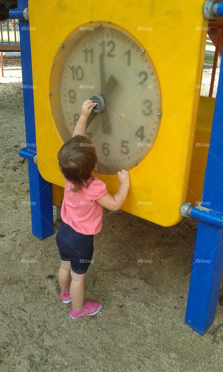 yellow clock at the park we play with and enjoy.