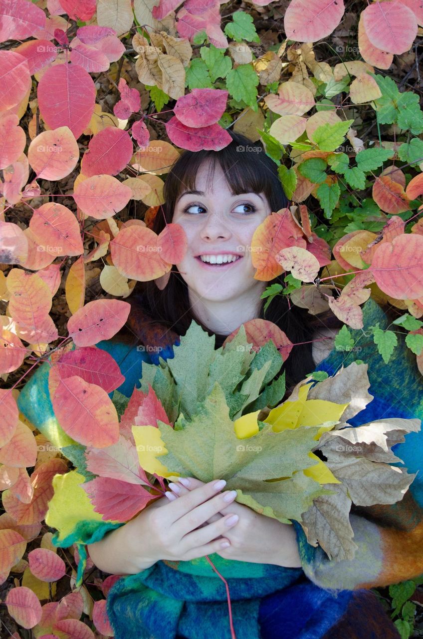 Smiling Girl on Autumn Background