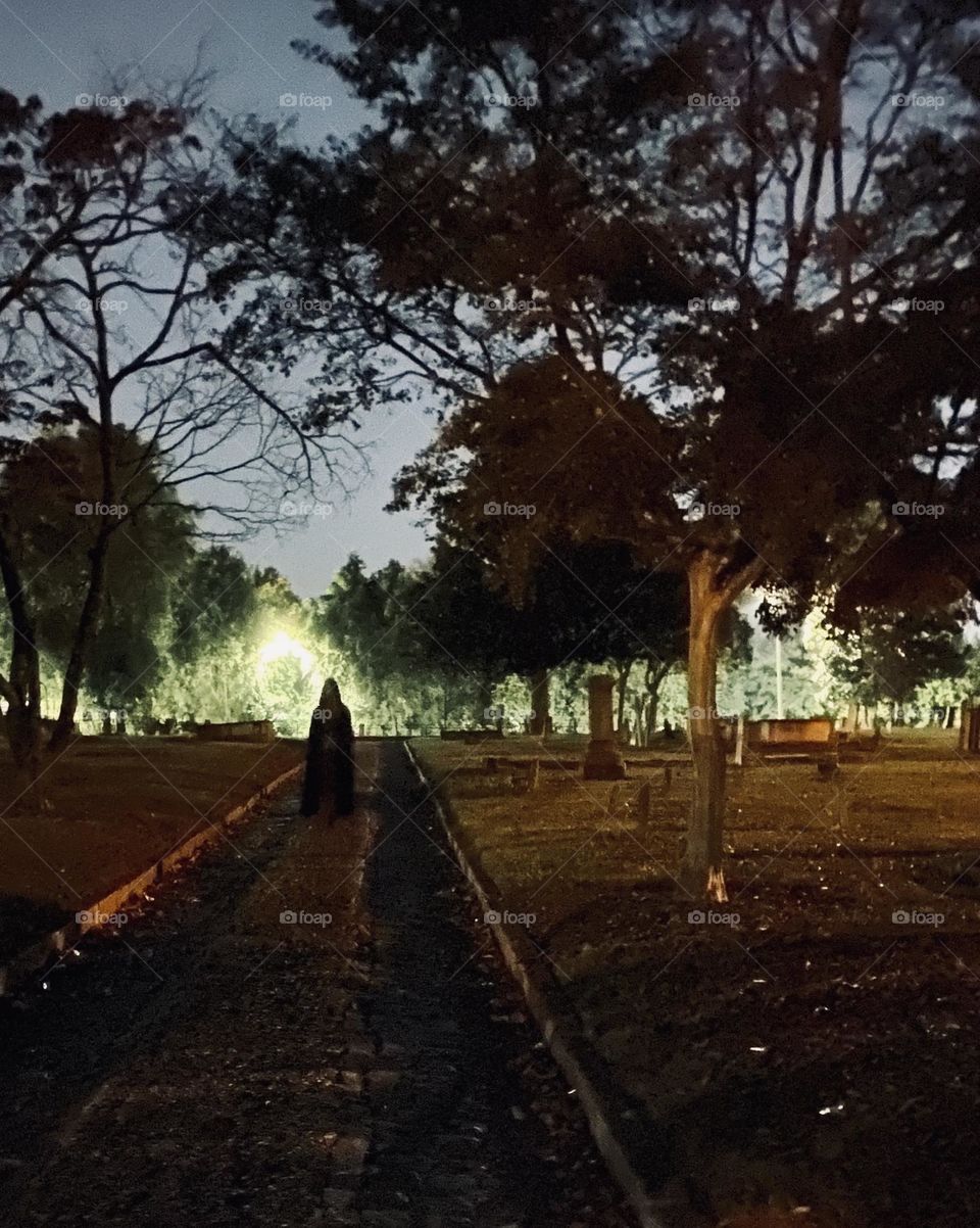 Cloaked figure in graveyard spooky 