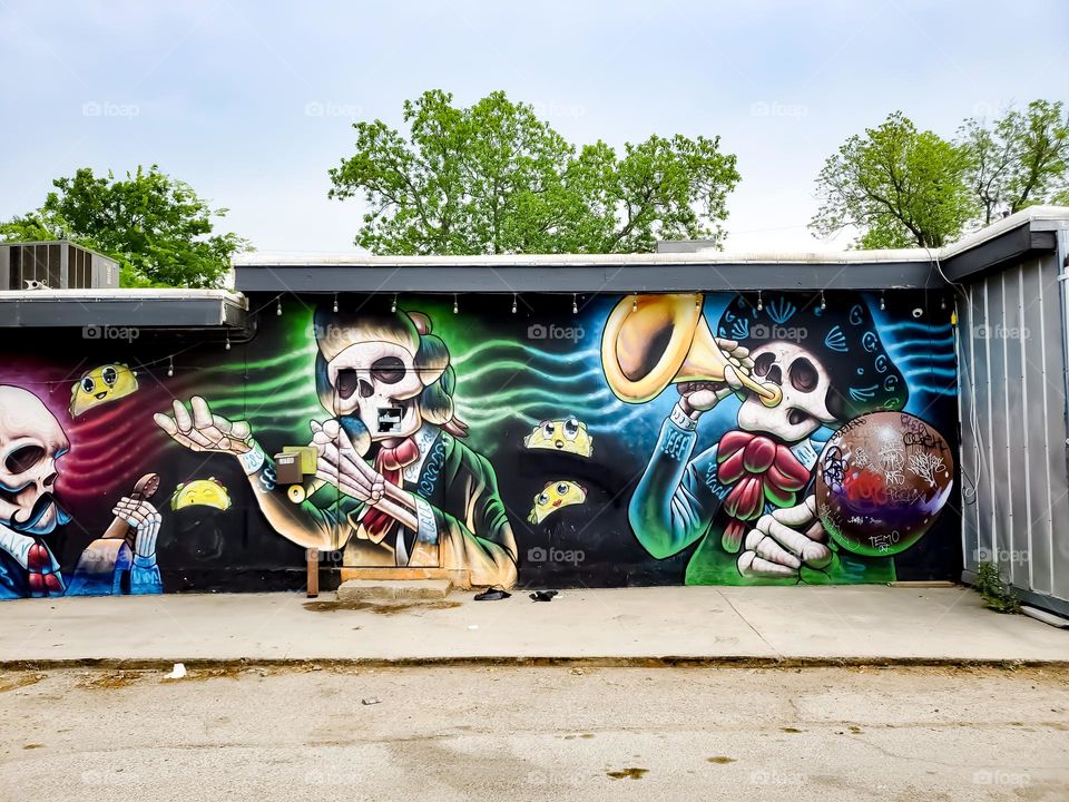 Street art celebrating Dia De Los Muertos/ Day of the Dead. A Mexican cultural tradition of remembering and celebrating those that have passed. The art depicts dead Mexican culture musicians.