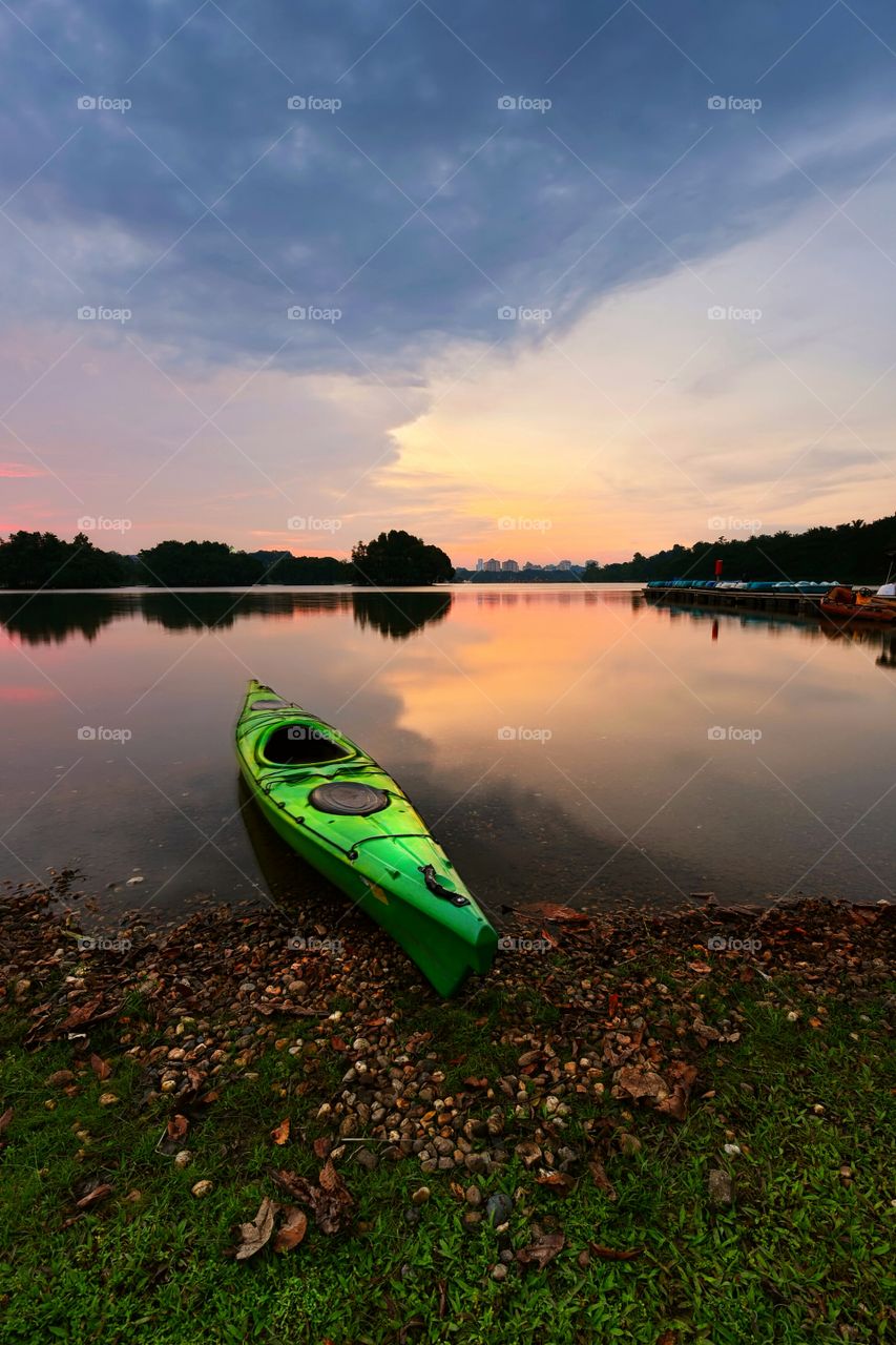 Canoe at lake during sunset with beautiful reflections