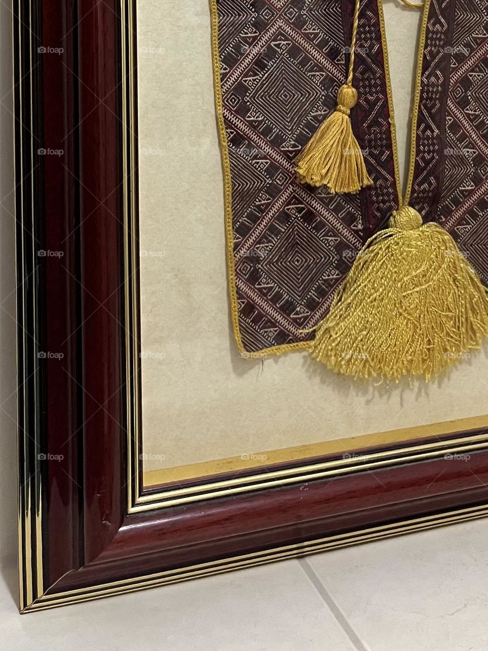 Traditional Konavle needlepoint in a red frame.