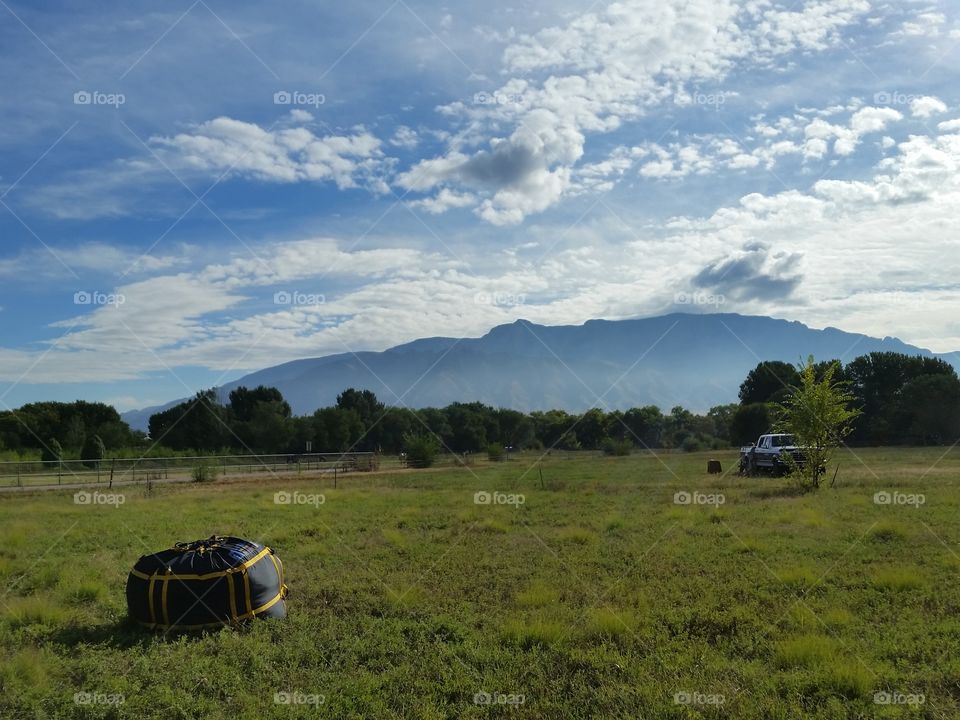 Lovely field, balloon bag, mountains and blue skies.