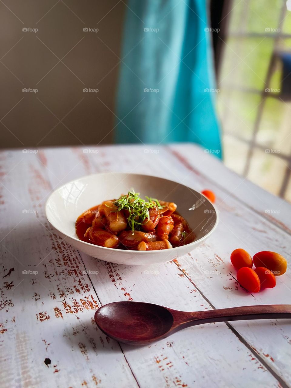 Spicy seafood dish on a white wooden table. View from eye level