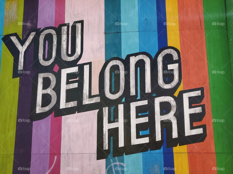 Colorful street art with the words You belong here.