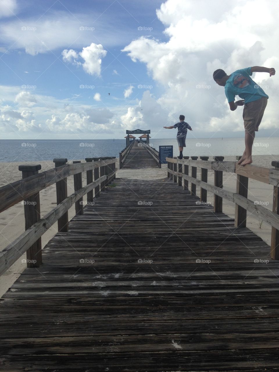 People walking on wooden pier