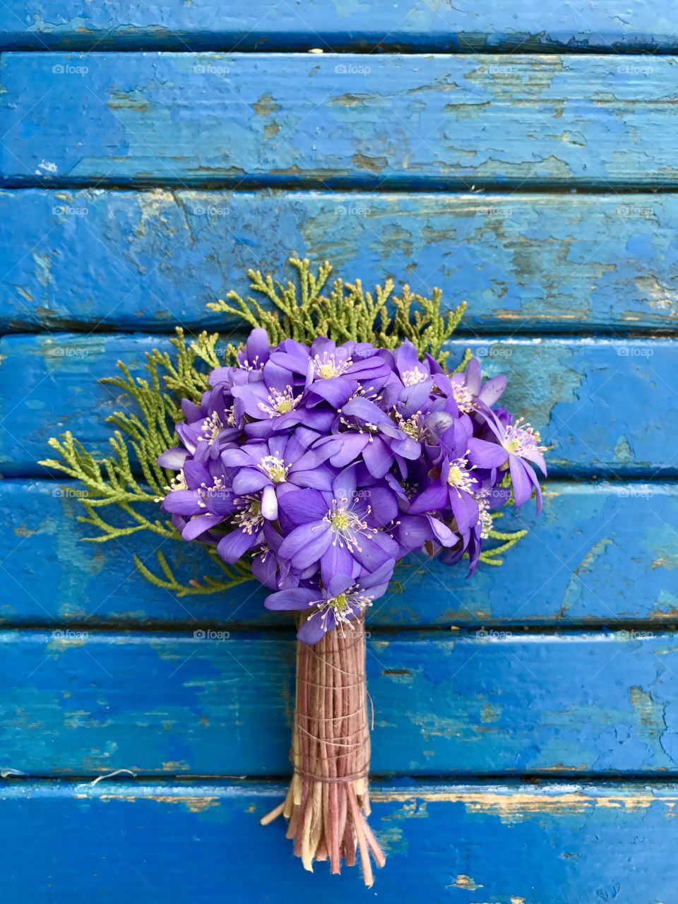 bouquet of first flowers on blu wooden background 