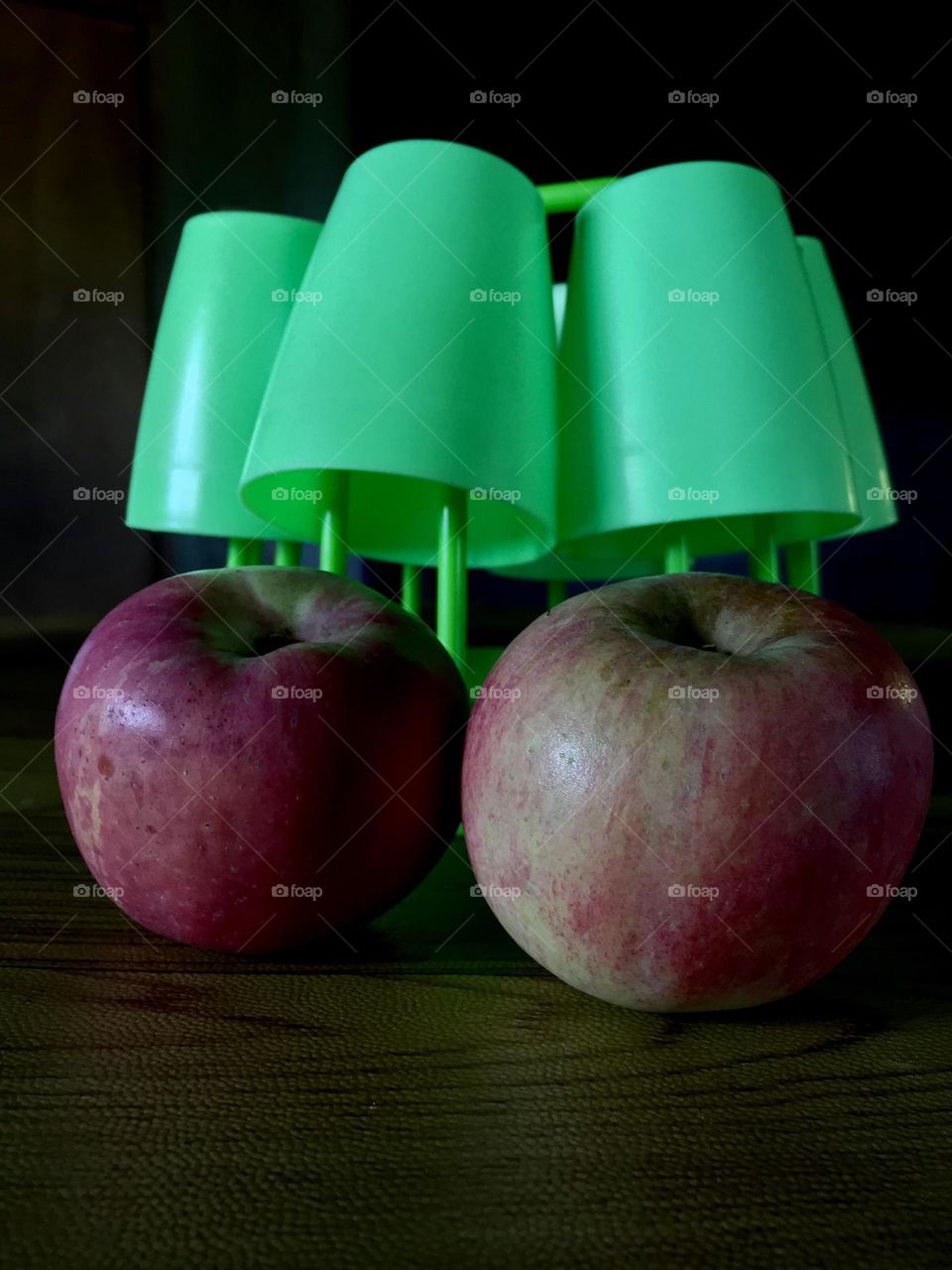 Neon green cups and two apples