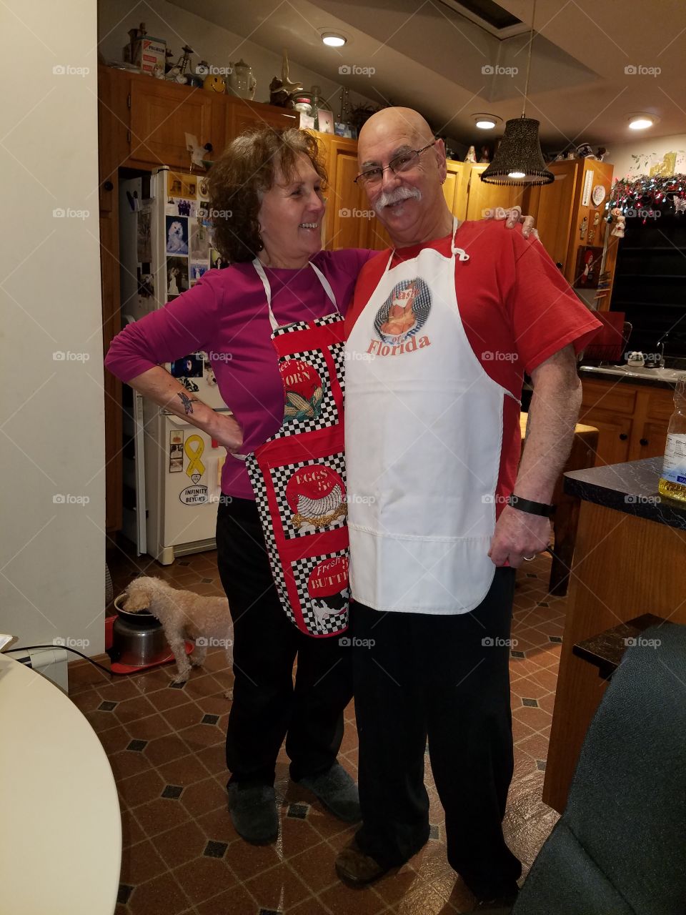 Happy smiling senior couple in kitchen