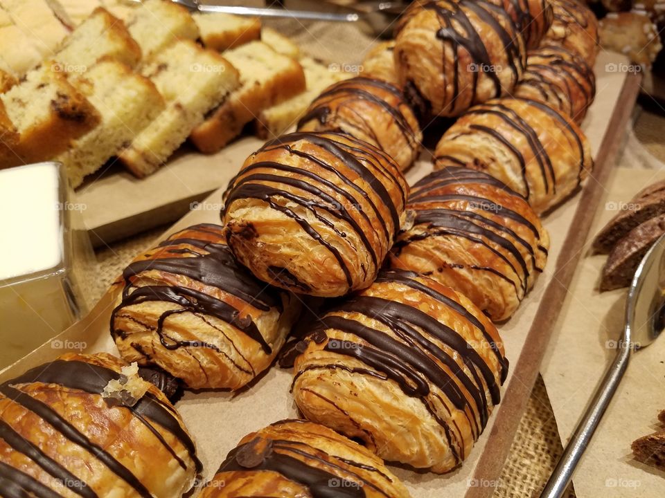 chocolate drizzle croissants in bakery