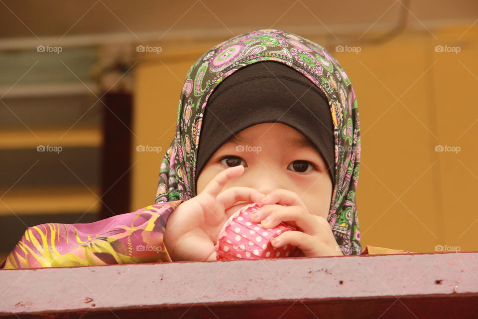 Close-up of a little girl holding cupcake