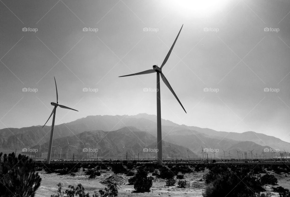 Wind power.
Wind turbines against desert hills. Black and white picture.