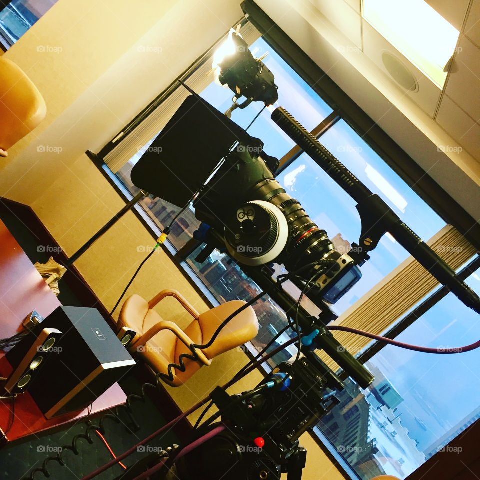 Video camera set up for a shoot in a skyscraper boardroom. 