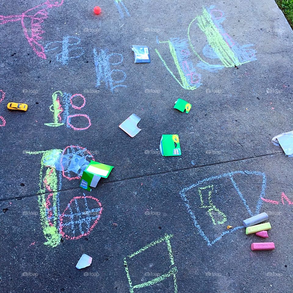Stuff of childhood. A driveway full of bright chalk drawings 