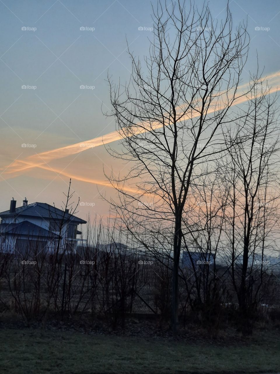 airplane condensation plumes seconds before sunrise