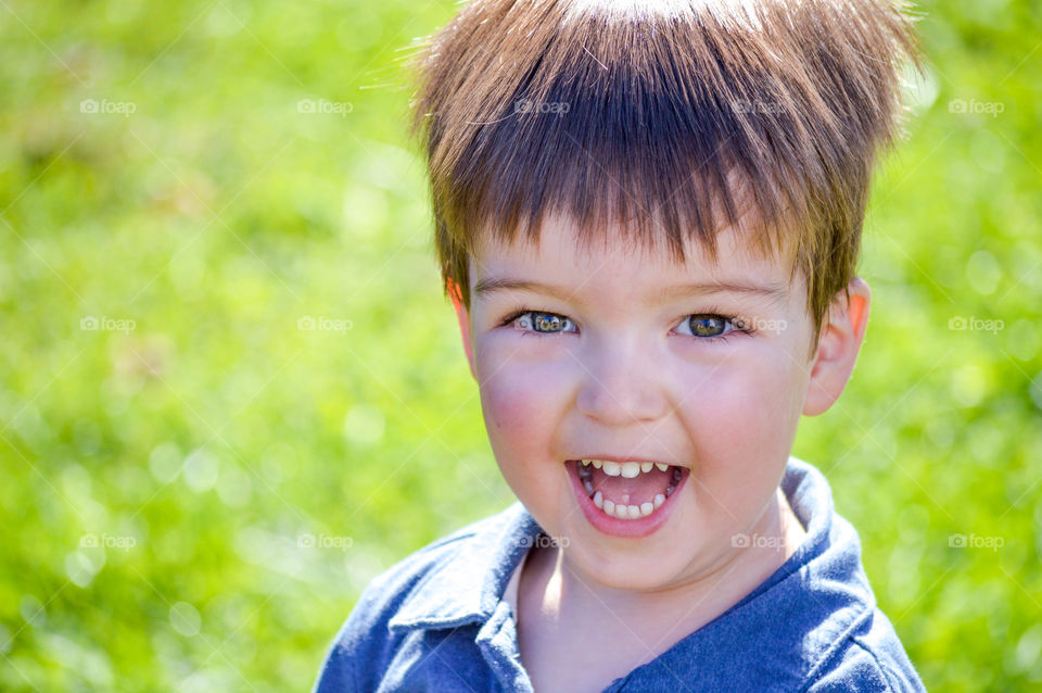 Portrait of a happy, smiling toddler boy outdoors