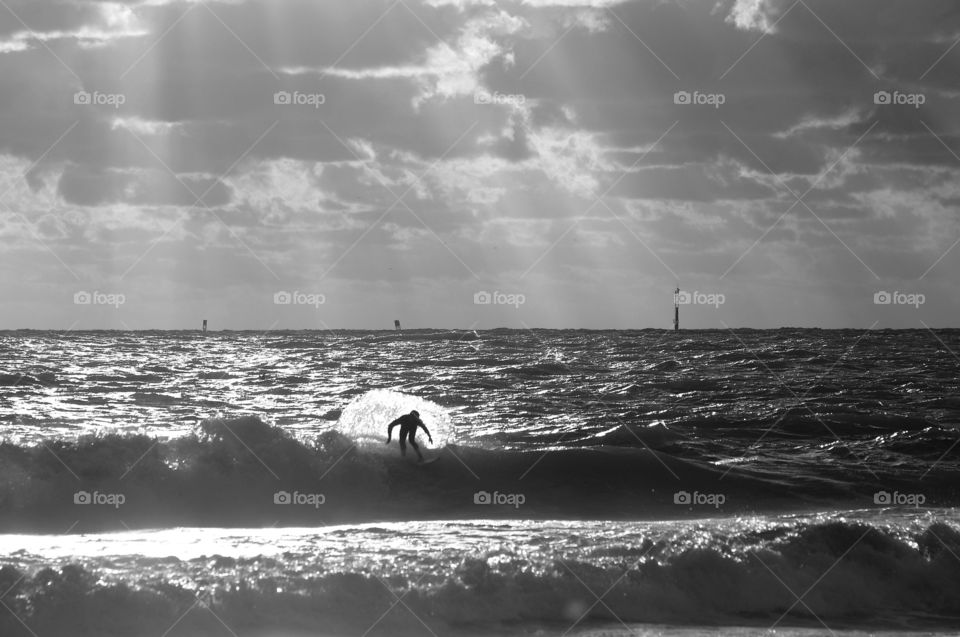 Silhouette of a person surfing in sea