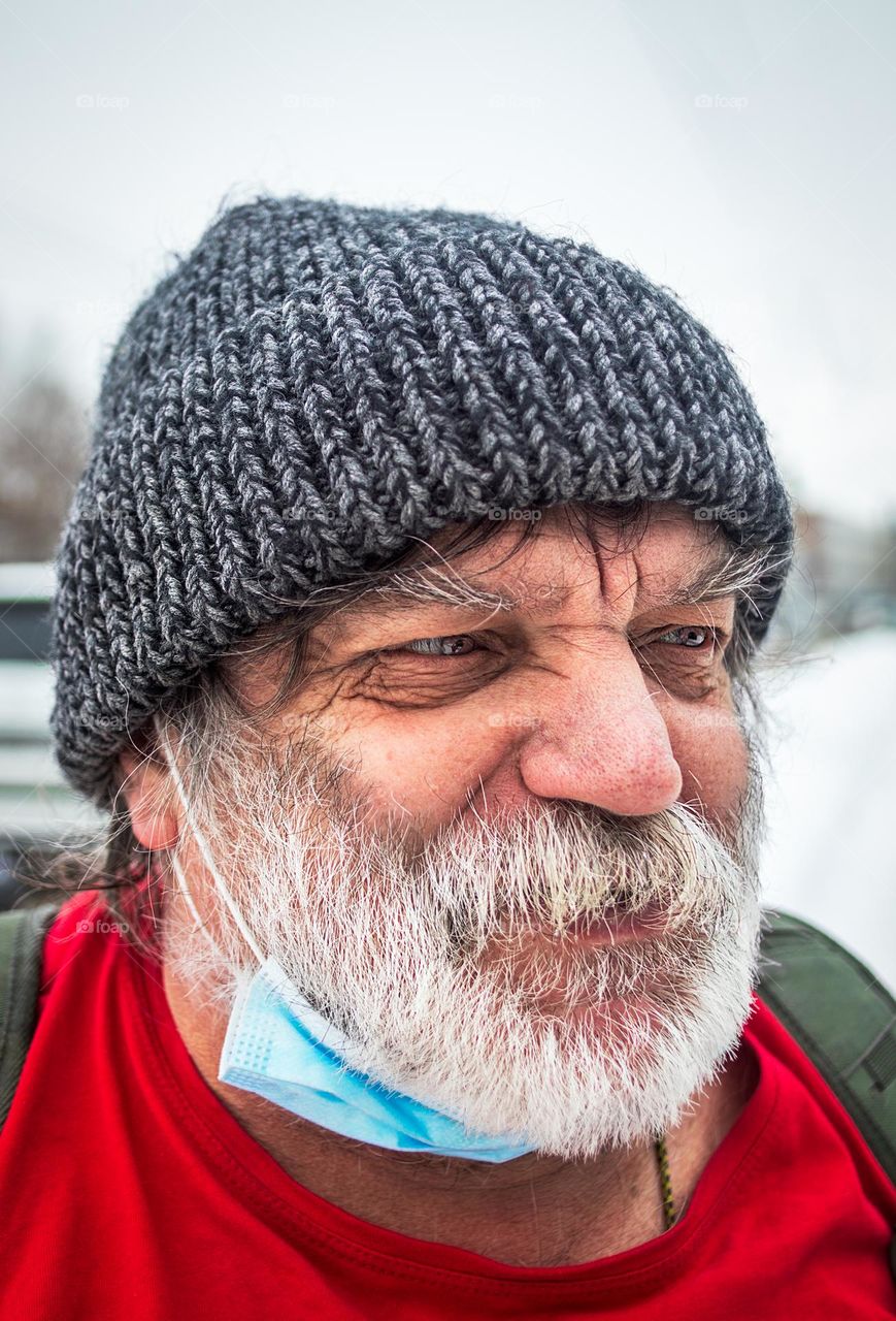 Man with rich mustache walking on a cold snowy day 