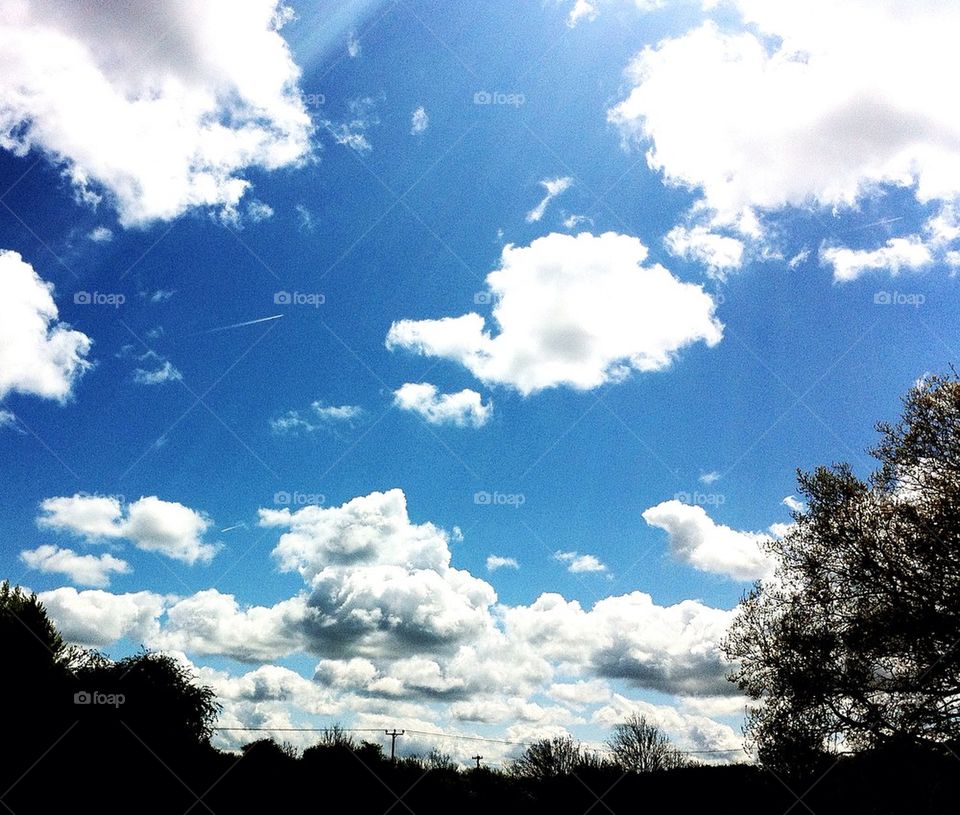 sky blue sunny clouds by judgefunkymunky