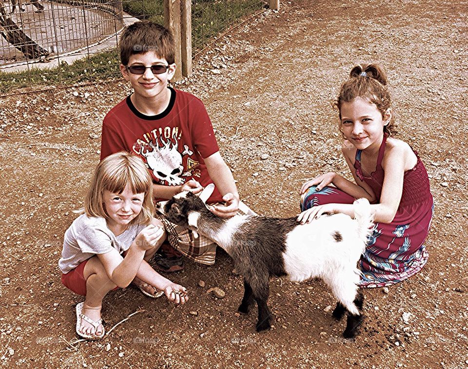 Nelson kids with a goat at Lake Tobias.