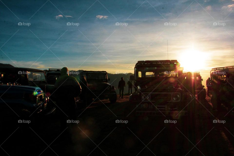 Sunrise that illuminates the car parking area on a hill in the Bromo mountains, East Java.