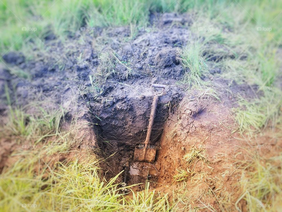 Problem at hand. Fixing a leaking water pipe. This pipe is the Only source of water for hundreds of cattle. Free State, South Africa. 