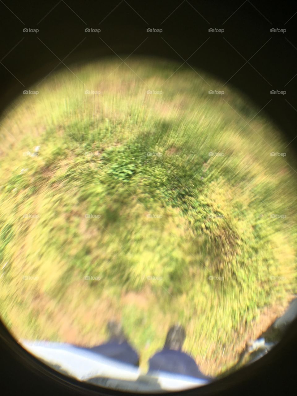 Looking down at the grass with the sun shining bright this is how it turned out. You can see my feet.